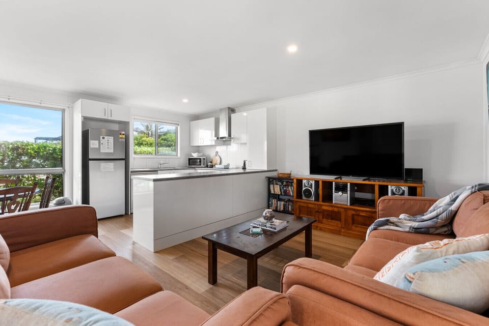 Settle into the living area after a day at Middleton Beach, where comfortable seating and a large TV create an easy place to relax, connect, or wind down for the evening.