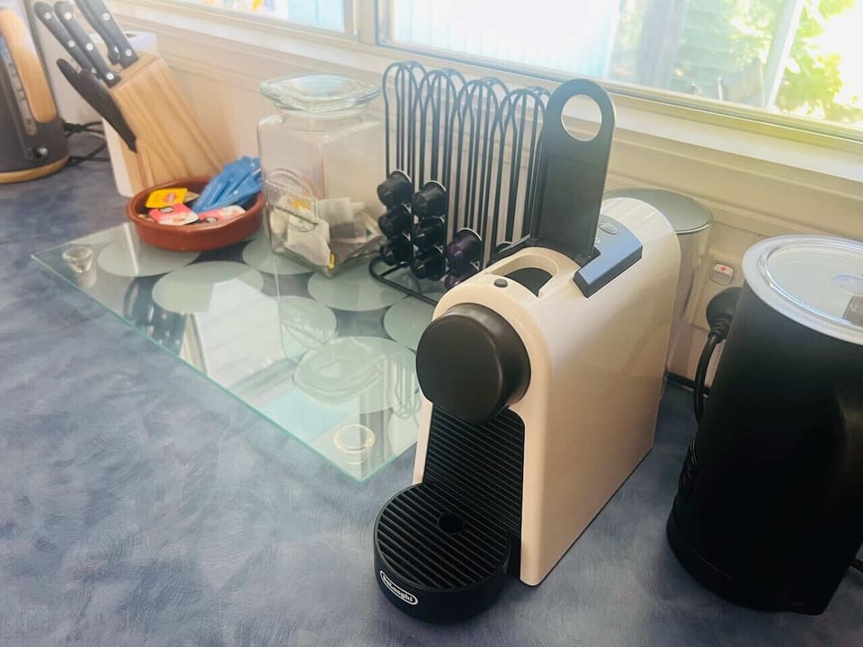 Nespresso coffee pod machine with pods provided.