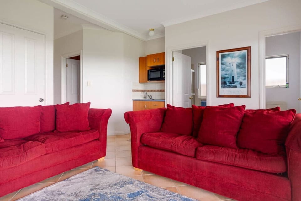 Downstairs, a secondary living area offers comfortable seating and a small kitchenette.