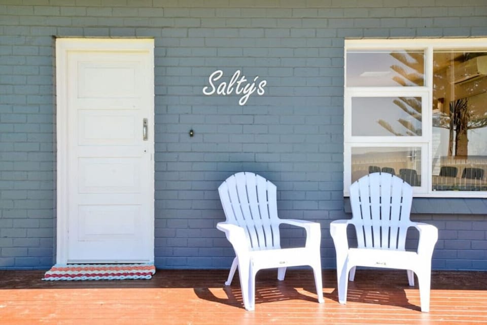 A welcoming front entry invites you to arrive and settle in, with chairs beneath the Salty’s sign offering a relaxed spot to pause and ease into your stay.