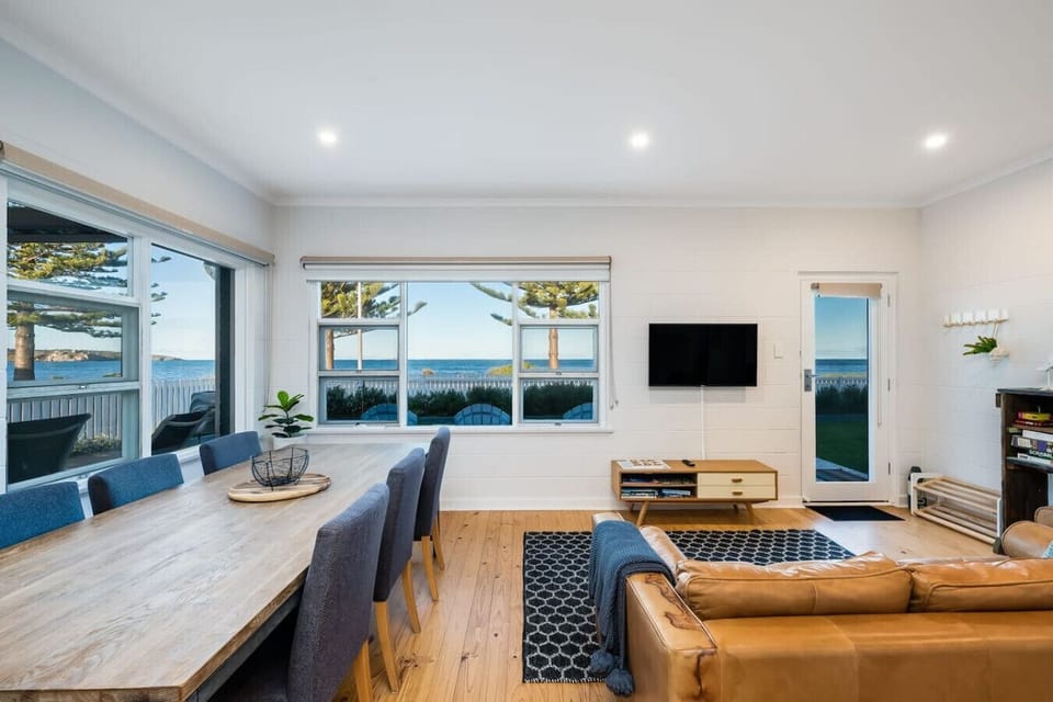 Share relaxed meals at the dining table while coastal light and ocean glimpses set the tone for slow evenings together.