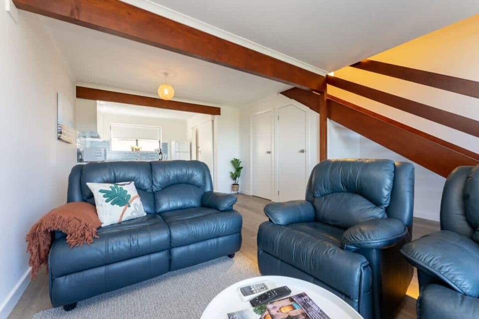 Unwind in the living area where comfortable seating and a Smart TV create an easy place to relax while soaking in sweeping coastal views.