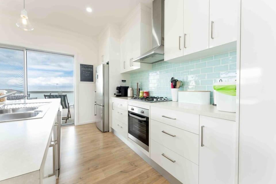 Cook with ease in the bright open kitchen, equipped with an oven, cooktop, microwave, dishwasher and Nespresso machine, while the island seating and generous prep space make family meals and morning coffee effortless.