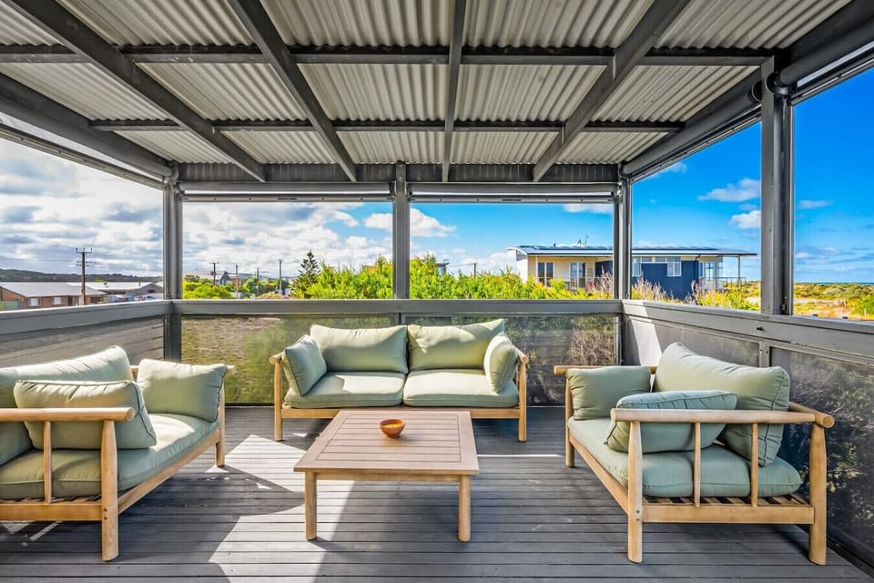 Unwind in the spacious outdoor living area, where cushioned seating and open views invite long afternoons of conversation, dining, or simply soaking up the fresh air.