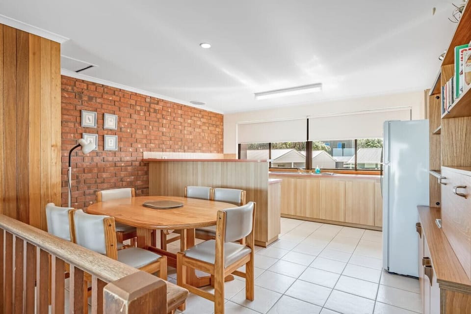 The upstairs level invites togetherness with an open plan living, dining and kitchen area.