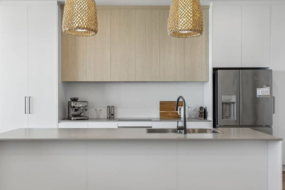 The modern kitchen centres around a stone island.