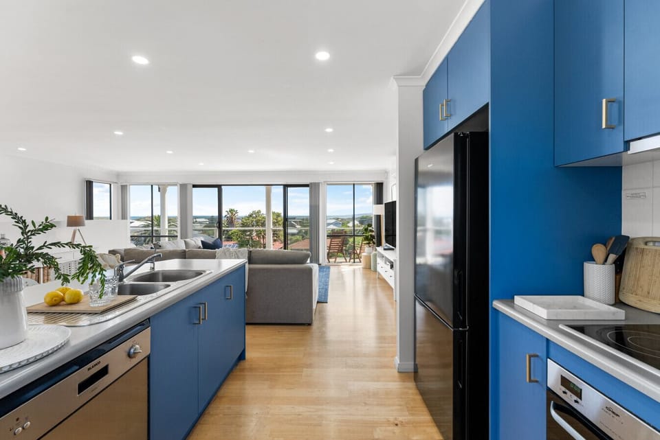 Cook and gather in the contemporary kitchen, where the island bench invites conversation over morning coffee or evening wines.
