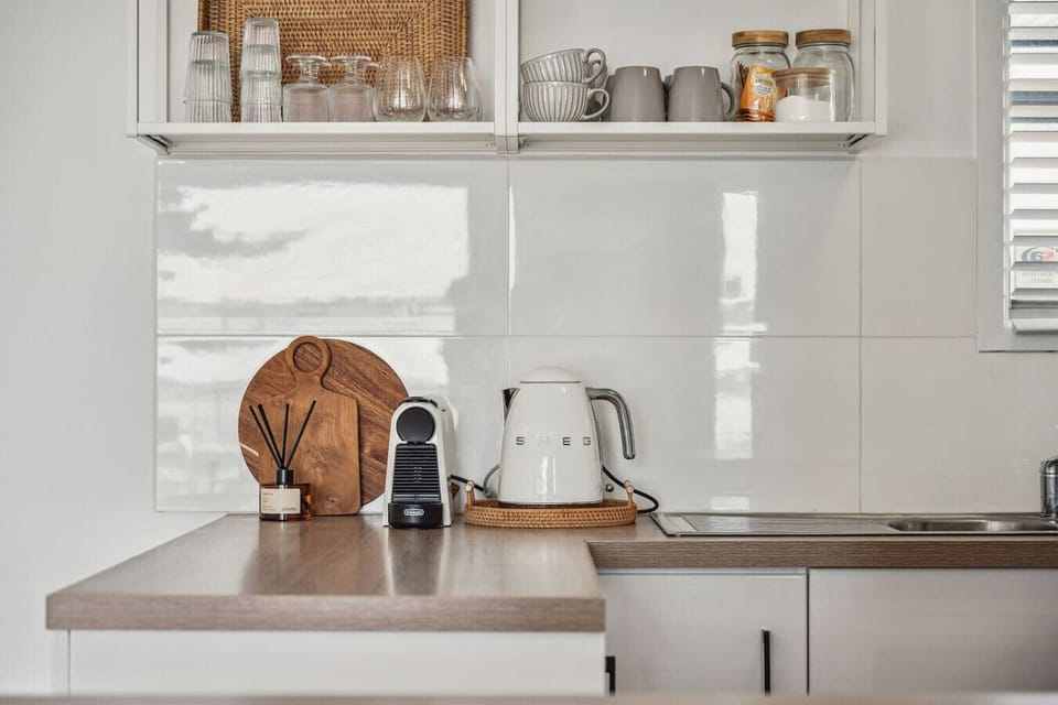 Start the day your way with a handy coffee station featuring a Nespresso machine, kettle, and everything you need for a perfect cup.