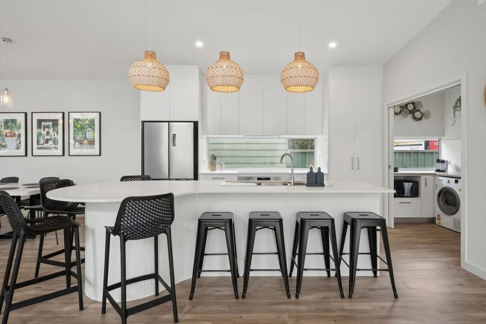 Breakfast bar seating under warm pendant lighting is perfect for casual meals.