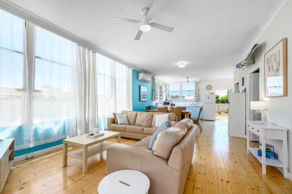 Settle into the living area after beach days, where comfortable seating and cooling make it easy to unwind with a movie or board game.