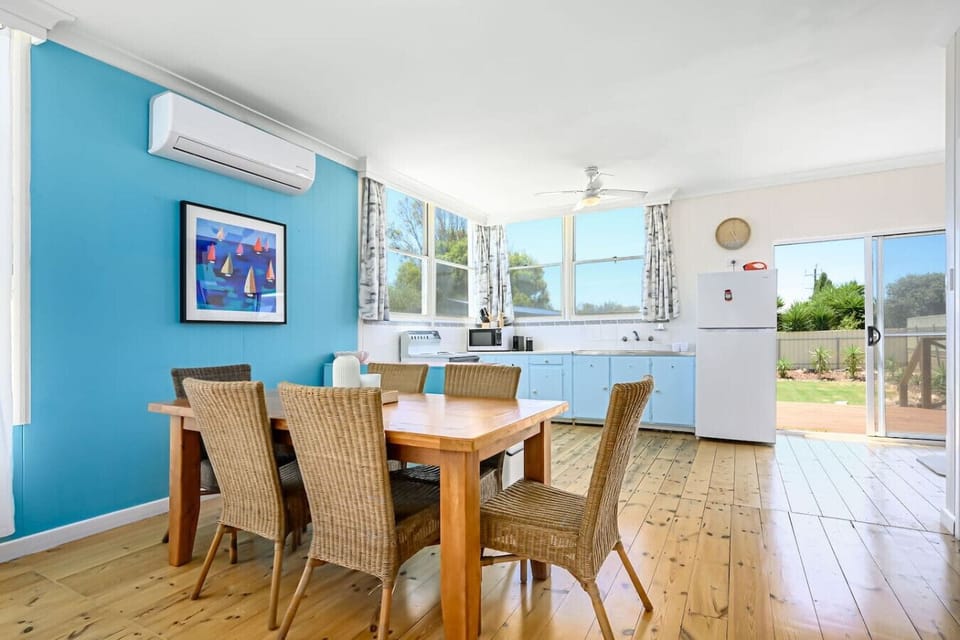 Gather around the indoor timber table, offering ample space to dine at home.