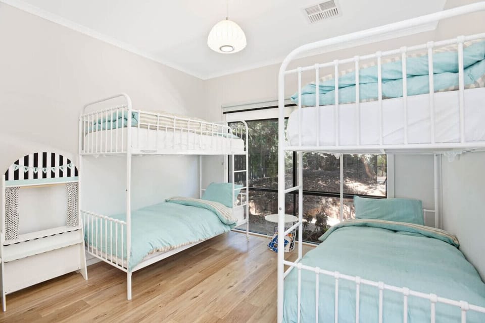 The fourth bedroom is designed for fun, with two bunk beds and space for stories, play, and laughter.