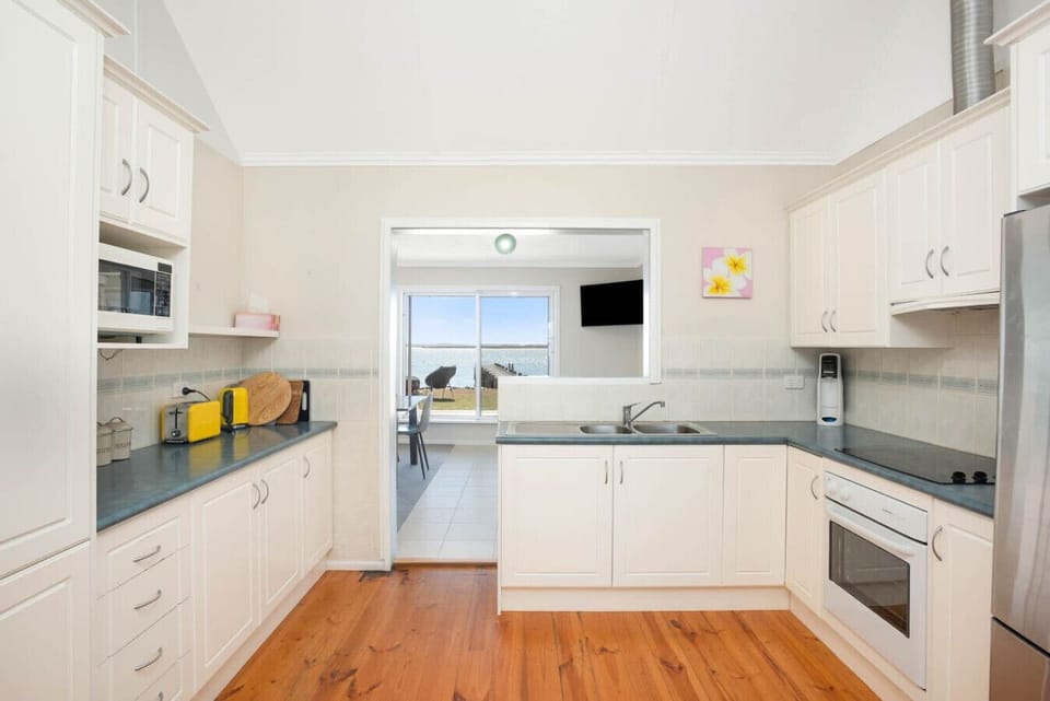 The kichen is well-equipped with ample bench space and modern appliances.