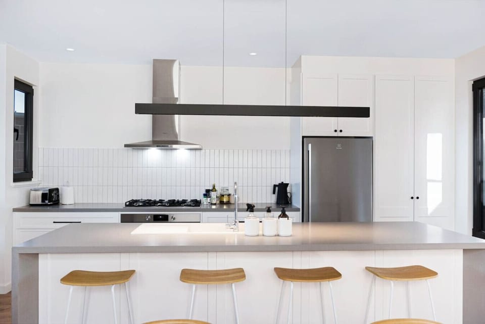 Prepare meals comfortably in the kitchen, where generous bench space allows multiple people to cook at once.