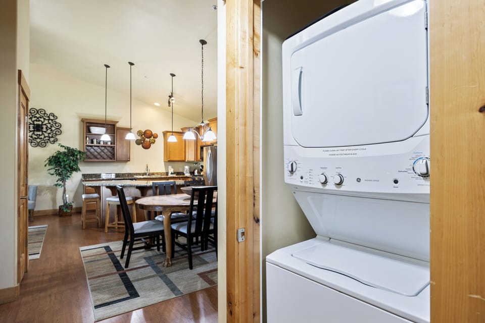 - In unit washer and dryer for extended stay convenience  
- Compact laundry space tucked away near dining area  
- Perfect for ski trips and longer family vacations