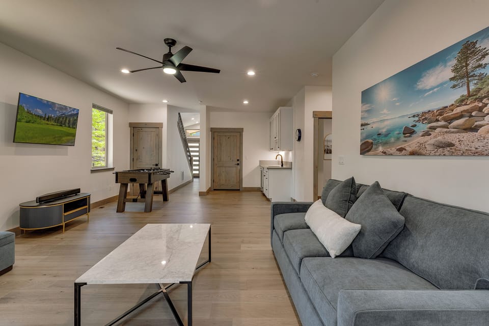 Entertainment room with Foosball table, wet bar, and TV
