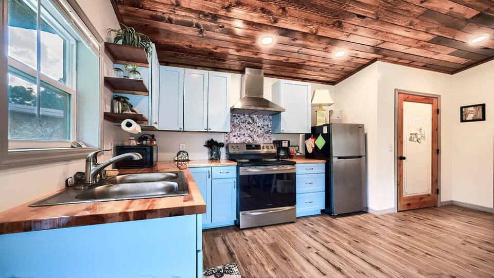 Full kitchen stocked with essentials! And yup, that’s a pantry in a tiny home