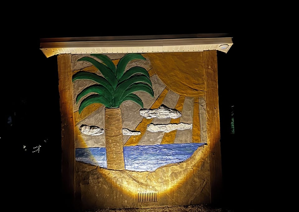 Lit up shot of mural on the laundry building.