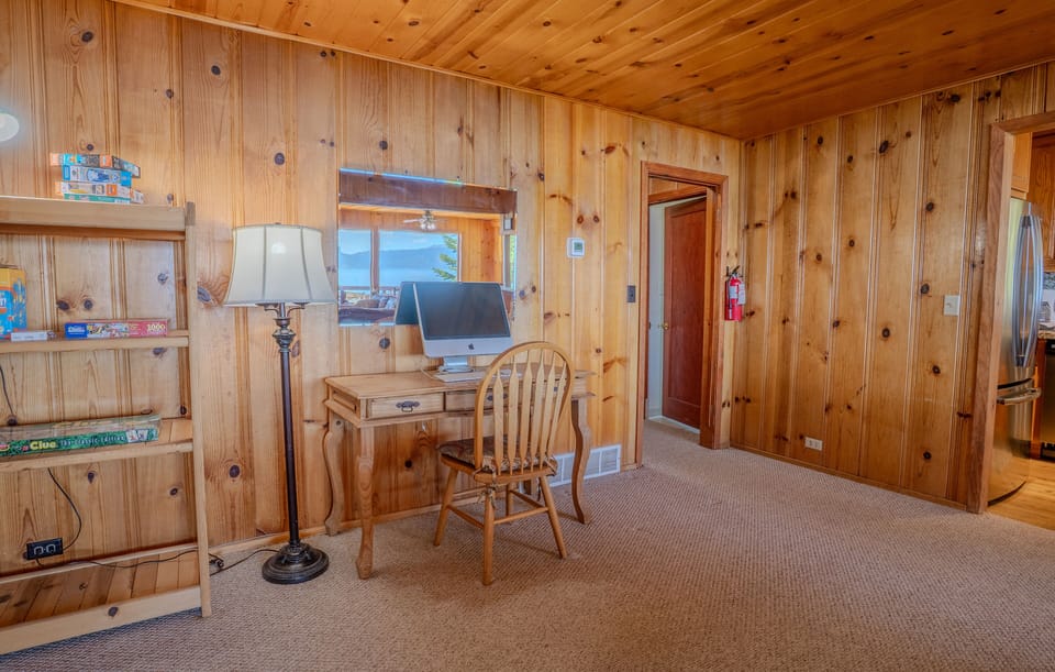 Separate desk in the living room offers a convenient space for checking emails or working remotely