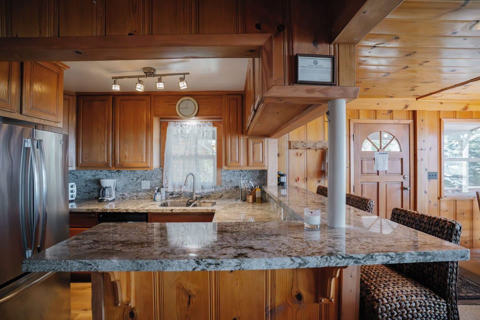 Compact yet fully equipped kitchen featuring stainless steel appliances and all essential cookware