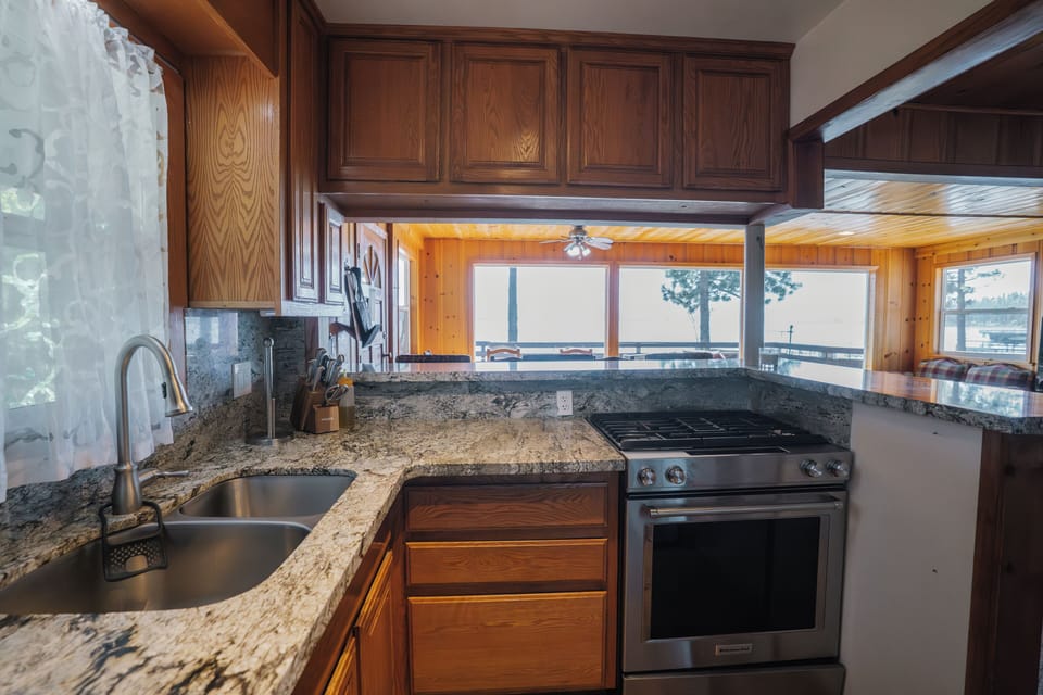 Compact yet fully equipped kitchen featuring stainless steel appliances and all essential cookware