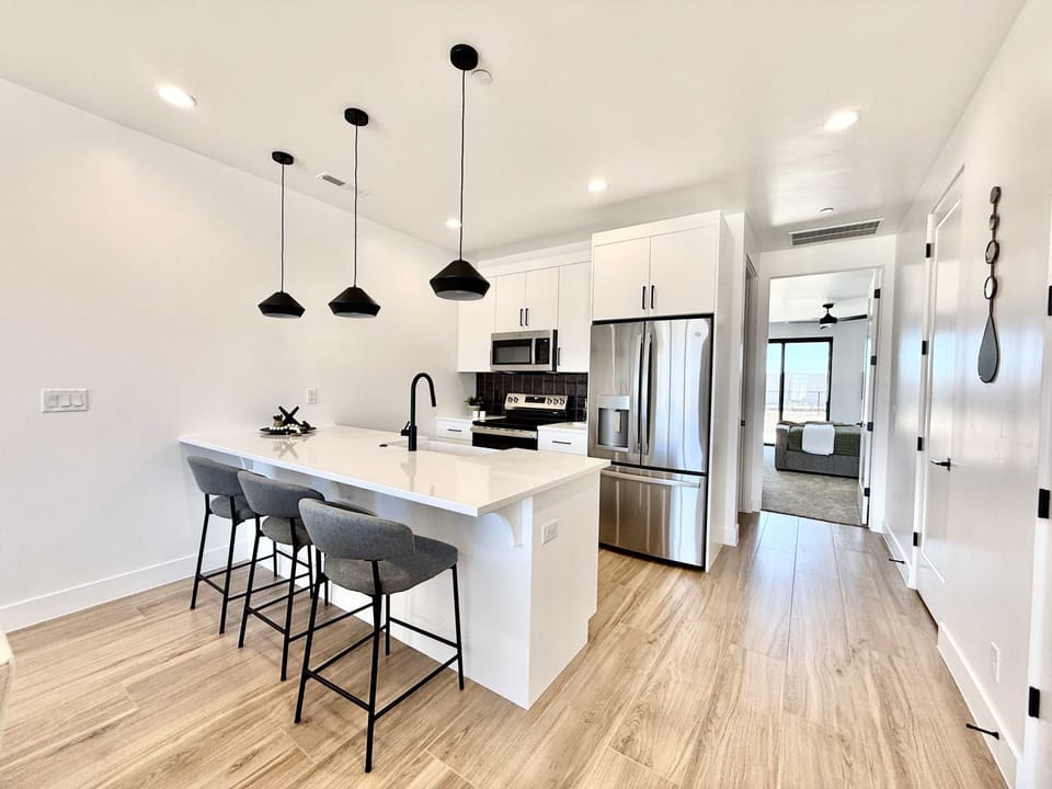 The fully appointed kitchen makes cooking up your favorite meals easy and fun! The bar offers additional seating.