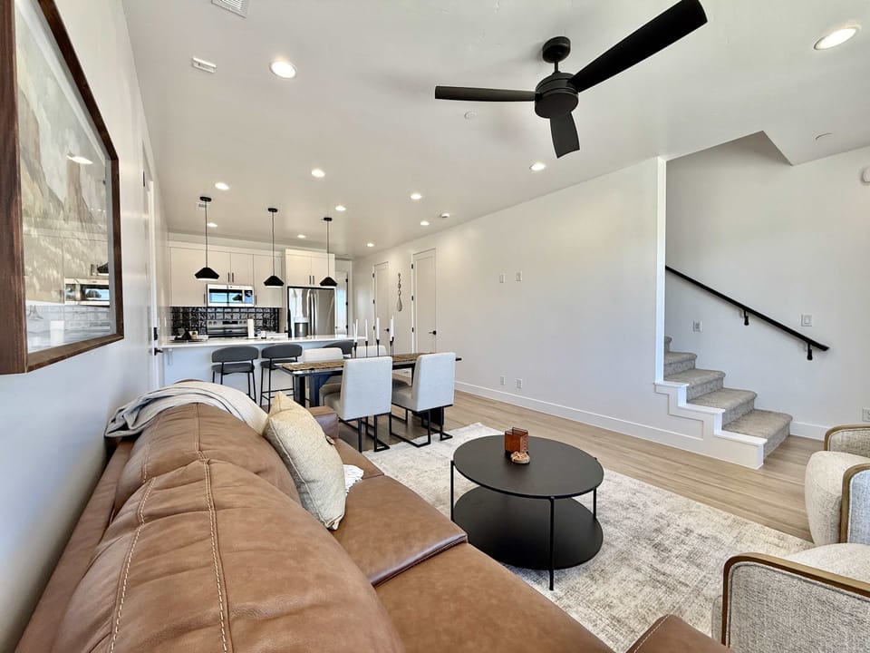 Comfortable couches and chairs furnish the living room, which blends seamlessly with the dining area and kitchen