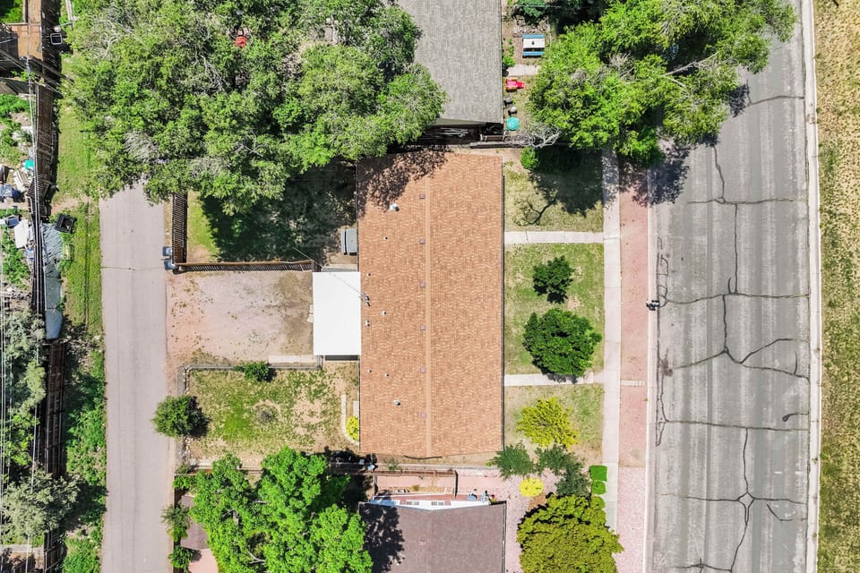 Aerial view of the property showing Alder Nest’s dedicated parking area at the rear and street-side options along the front.







