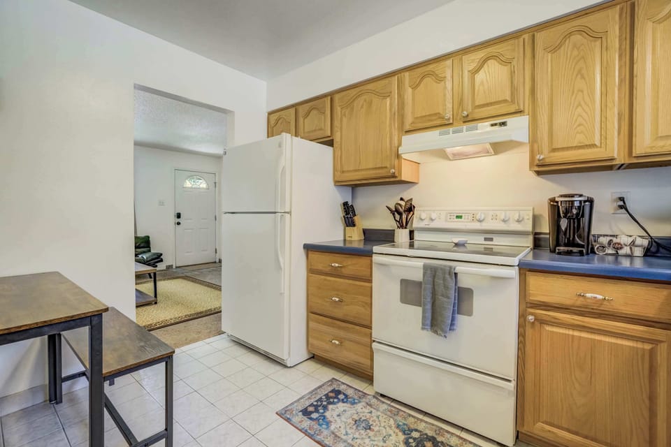 This efficient kitchen pairs full-size appliances with warm wood cabinetry and a coffee maker to start your mornings right.

