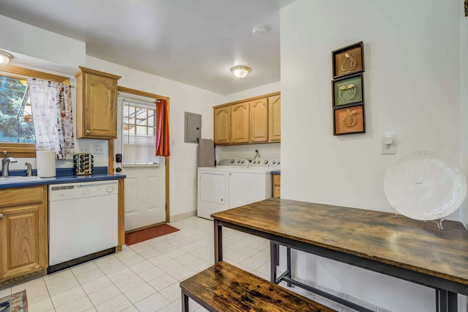 The kitchen opens to a sunny back door and features a dishwasher, spice rack, and in-unit laundry for added convenience.







