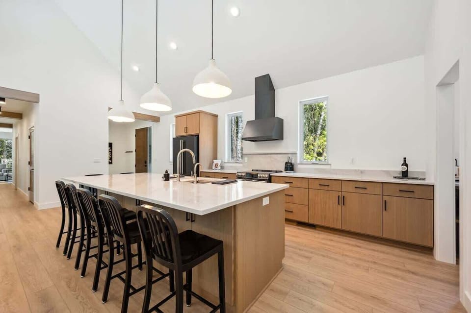 This high-end chef’s kitchen features GE Café appliances, All-Clad cookware, and a spacious island perfect for cooking together or catching up over wine.