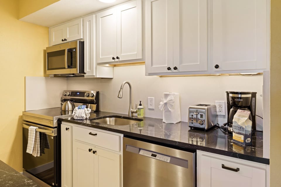 A Stainless steel Stove, Microwave, and Dishwasher
