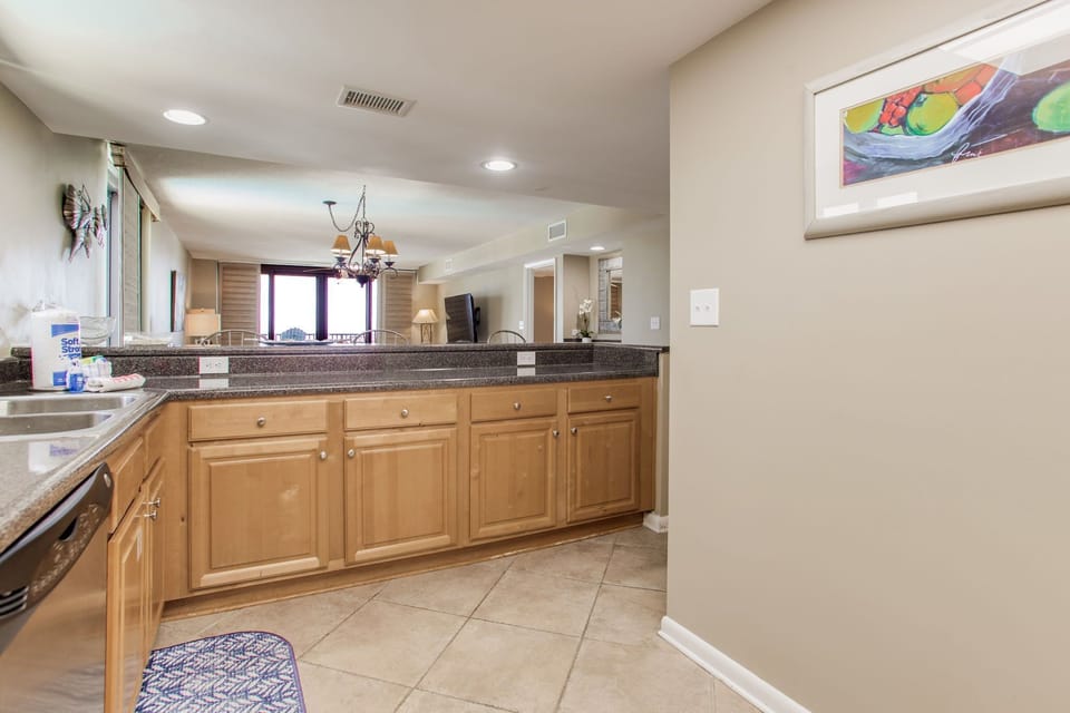 Open kitchen with modern appliances and Gulf views at Wind Drift