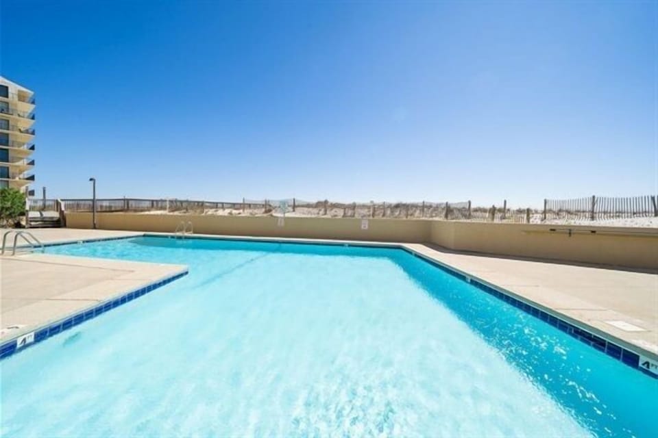 Outdoor pool with Gulf views at Wind Drift Orange Beach beachfront vacation resort