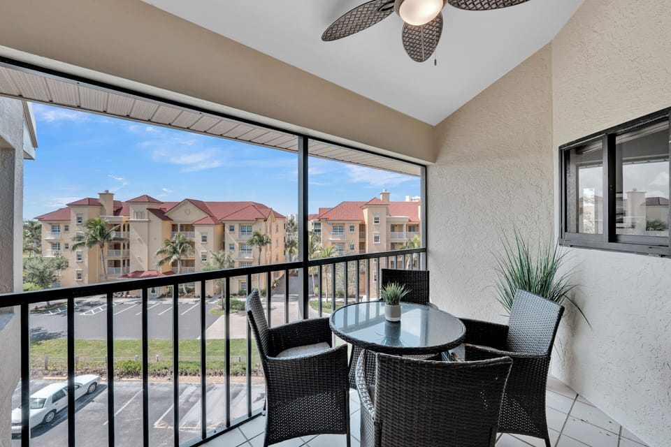 Relax on the screened in balcony. 