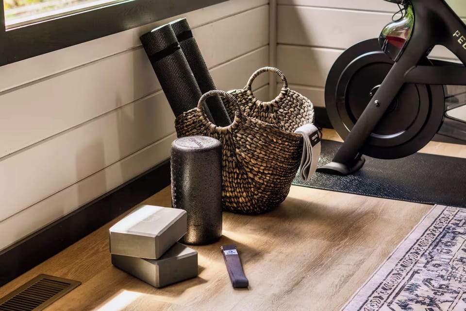 A cozy workout corner featuring a stationary bike and yoga accessories for a balanced fitness routine.