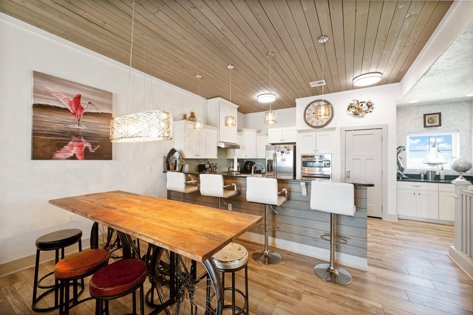 Your gourmet kitchen features a stunning wood-plank ceiling, gleaming stainless appliances, and a beautiful island where you'll gather for meals and memories.