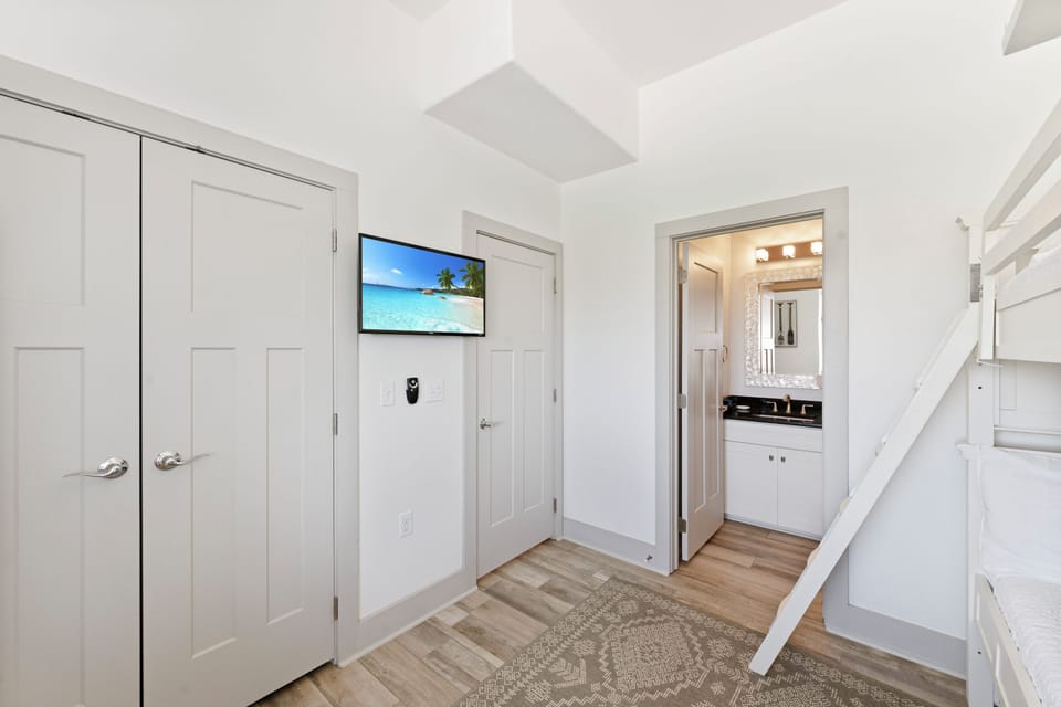 Step into your bright, open hallway featuring coastal charm with crisp white finishes and modern amenities for your comfort.