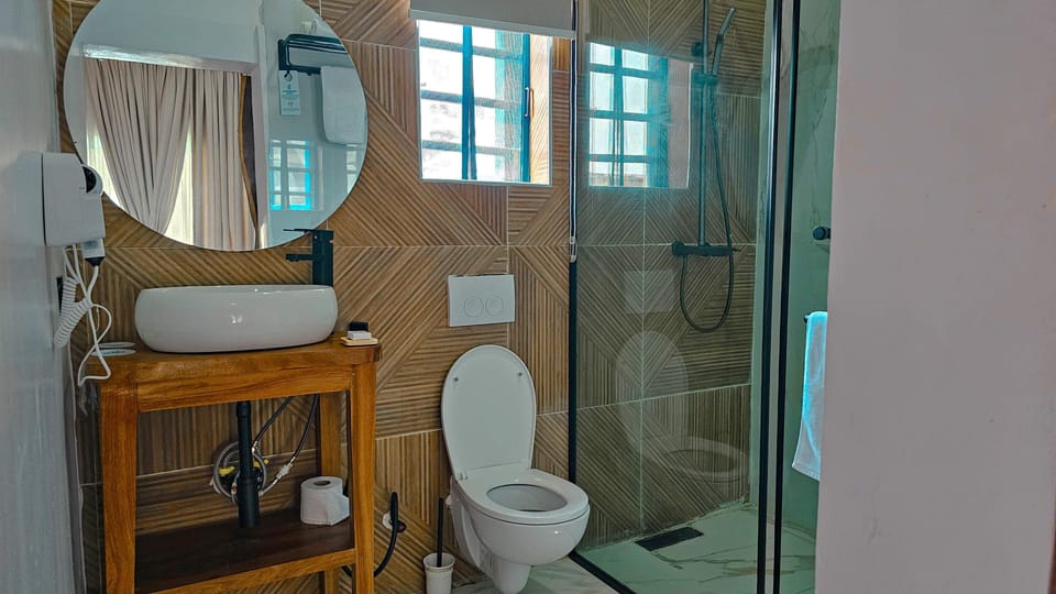 Luxury Room, Ocean View | Bathroom | Shower, hair dryer, bathrobes, towels