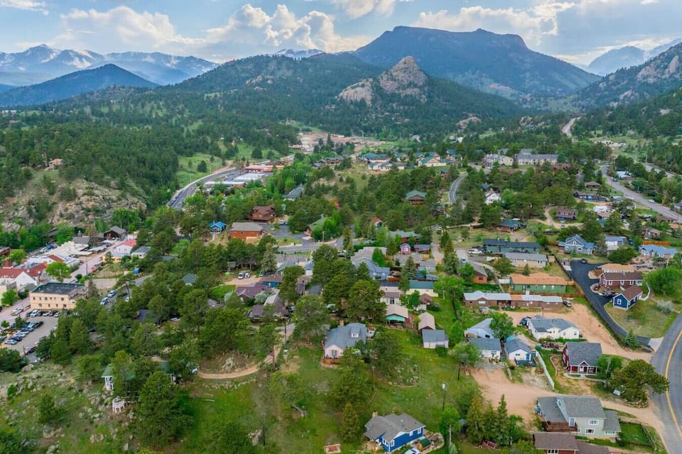 The house is in the center of the frame and downtown Estes is to the left, a few blocks away.