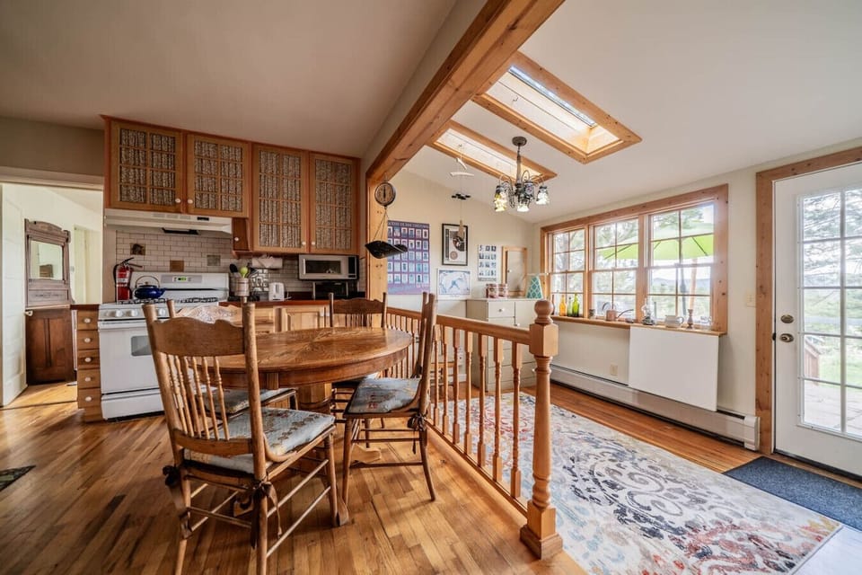 There is a small dining area in the kitchen where people can hang out, play cards, or be social while someone is cooking