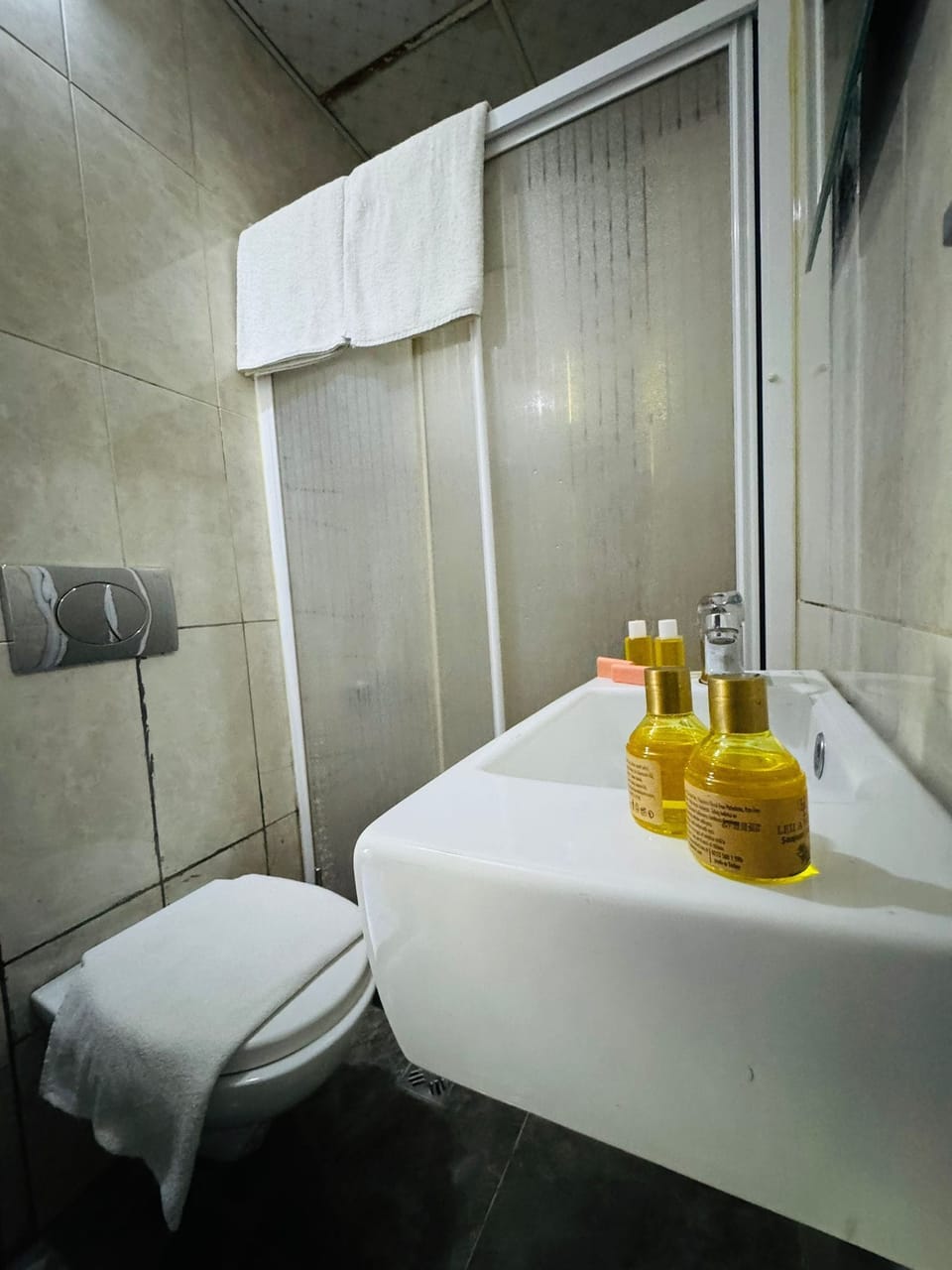 Shower, hair dryer, slippers, towels