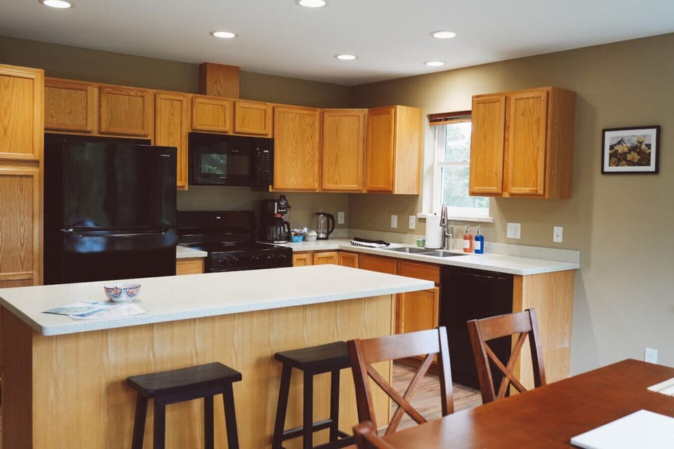Cook, gather, and unwind in this fully equipped kitchen with bar seating and natural light.