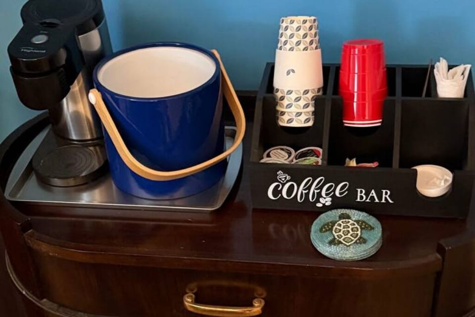 Keurig coffee machine with coffee, tea, hot chocolate pods and snacks provided. 
