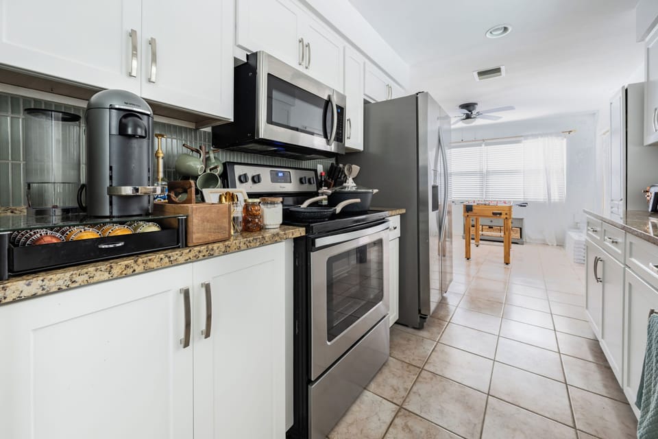 Full kitchen with pots and pans, utensils, and a selection of spices available. 