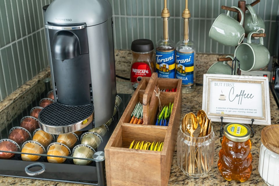 A selection of Nespresso pods, teas, decaf Nescafé, and hot cocoa are provided. 