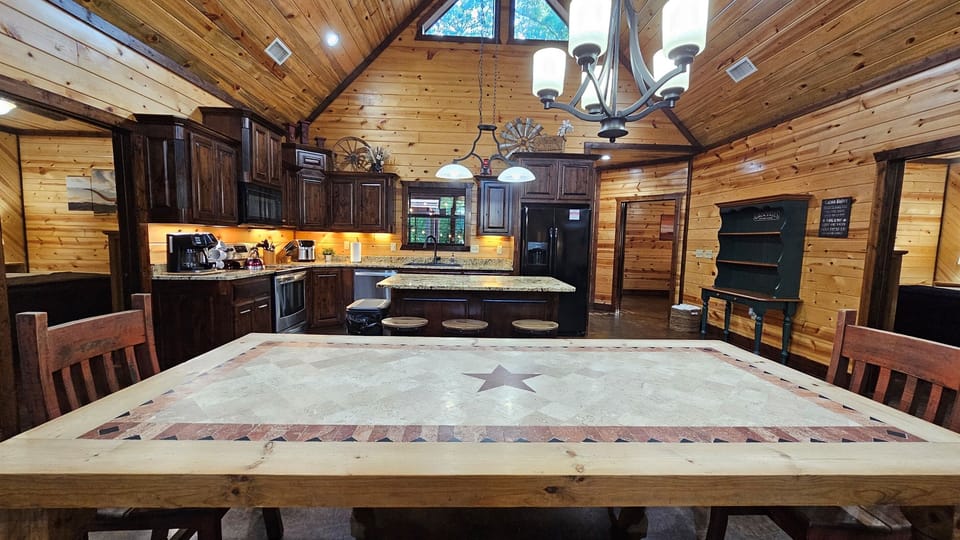 Kitchen: Culinary adventures await in this spacious retreat with rich wood accents and warm lighting!