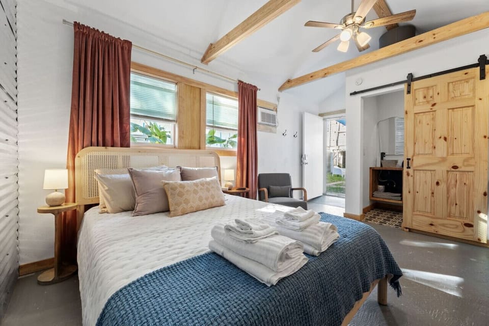 Relaxing bedroom with soft linens and natural light.