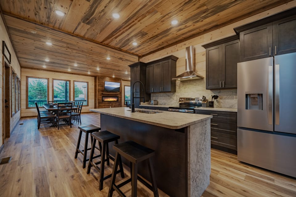 Kitchen with stainless steel appliances and cooking supplies. 