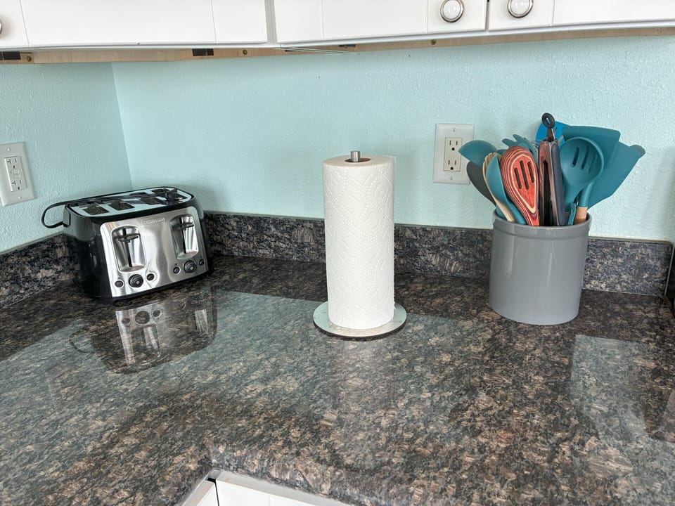 Toaster, utensils, and space for prepping snacks or drinks.